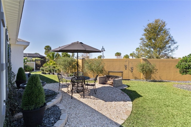 view of yard with glass enclosure, a patio, and a fenced backyard