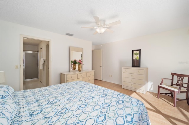 bedroom featuring ceiling fan, a textured ceiling, and light hardwood / wood-style flooring