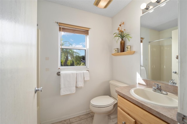 bathroom featuring tile patterned floors, vanity, a textured ceiling, a shower, and toilet