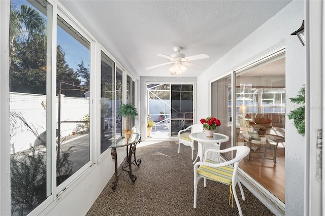 sunroom / solarium with ceiling fan and a healthy amount of sunlight