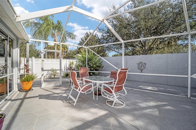 view of patio with glass enclosure