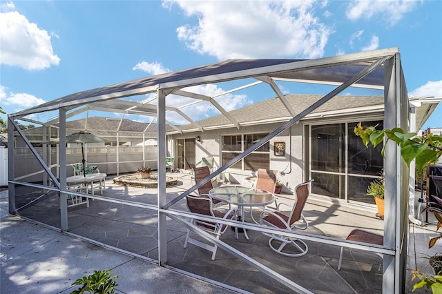 view of patio / terrace featuring glass enclosure