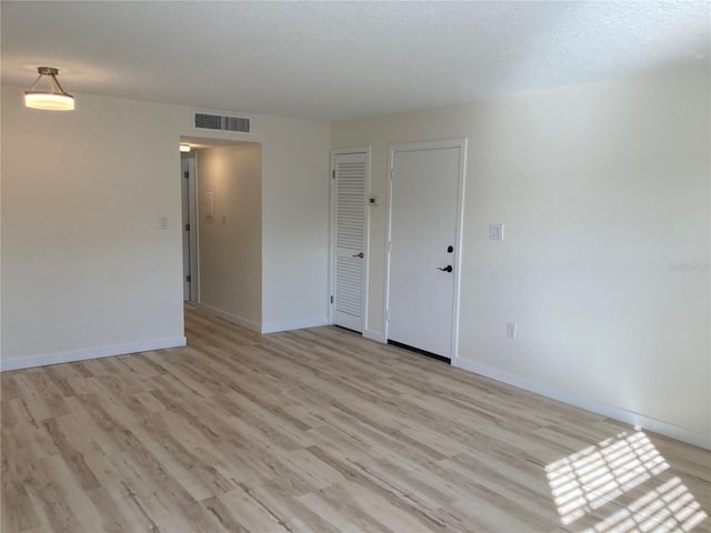 empty room with light hardwood / wood-style floors