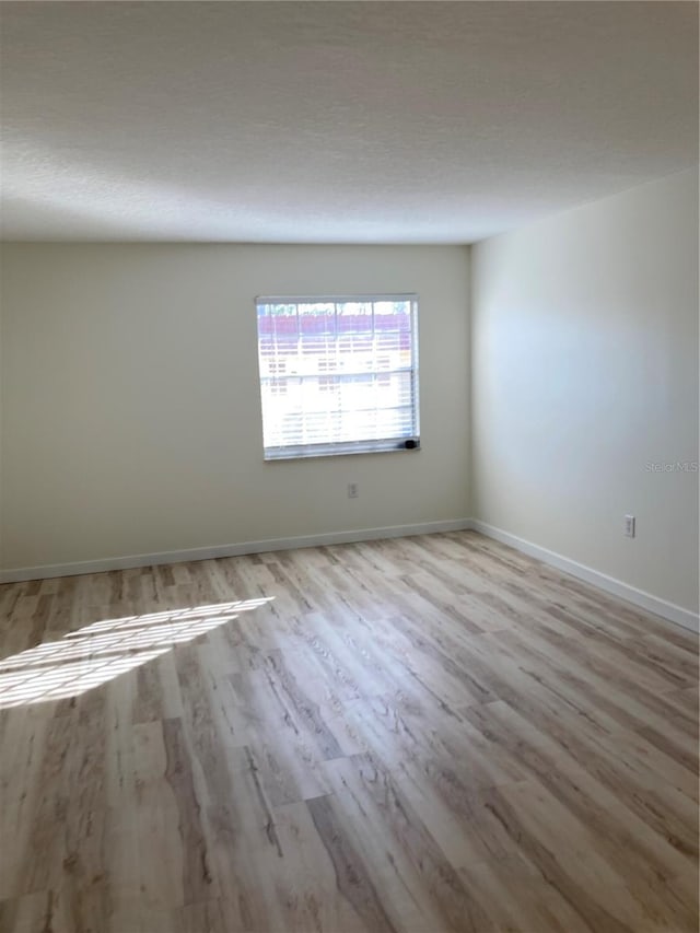 unfurnished room with light hardwood / wood-style flooring