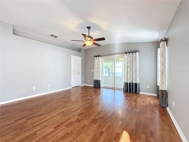 unfurnished room featuring lofted ceiling, ceiling fan, and dark hardwood / wood-style floors