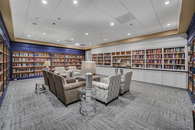 home theater featuring built in shelves and light colored carpet