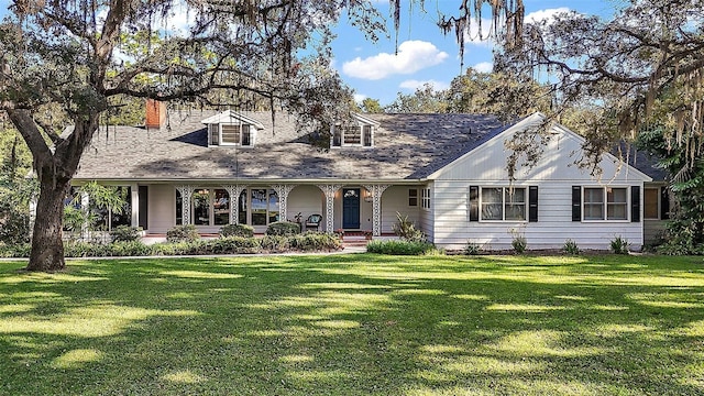 cape cod-style house with a front yard