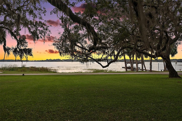 view of home's community featuring a yard and a water view