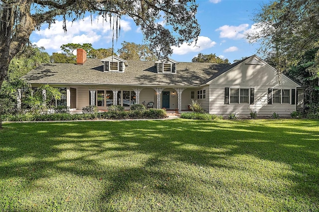 new england style home featuring a front yard