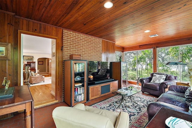 living room featuring wooden walls and wooden ceiling