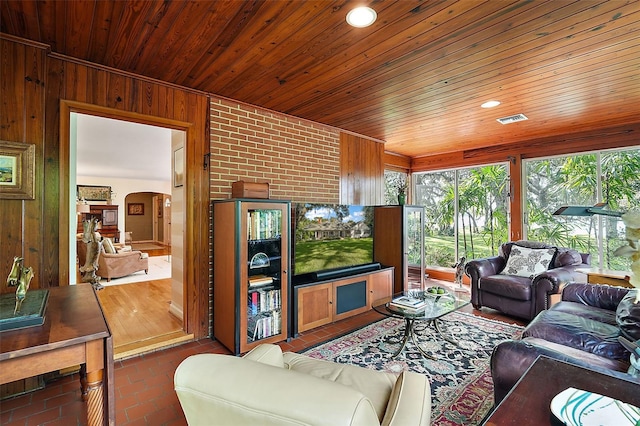 living room with wooden walls and wood ceiling