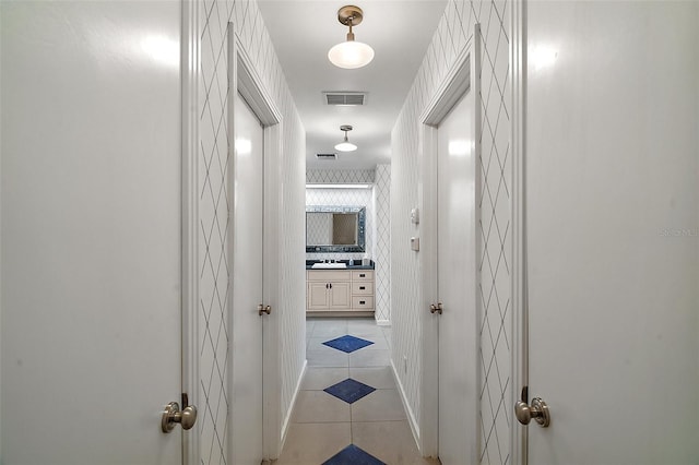 corridor with light tile patterned floors