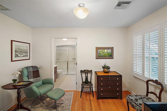 sitting room featuring a healthy amount of sunlight and light wood-type flooring