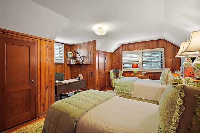 bedroom featuring wood-type flooring, vaulted ceiling, and wooden walls