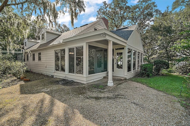 back of house featuring a sunroom