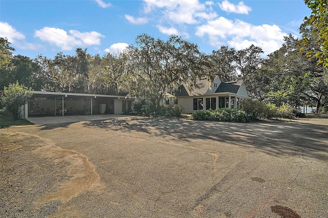 view of front of property featuring a sunroom and a carport