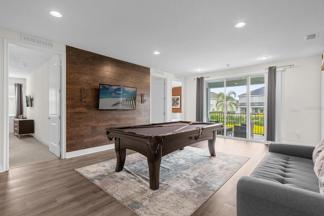 playroom featuring wood-type flooring, wooden walls, and pool table