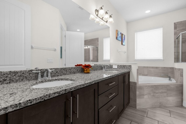 bathroom with vanity and independent shower and bath