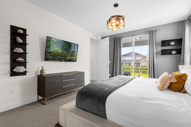 bedroom featuring carpet flooring, access to outside, and a notable chandelier