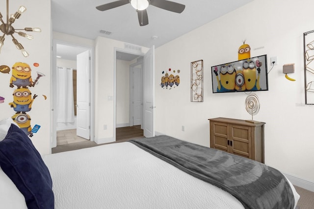 carpeted bedroom featuring connected bathroom and ceiling fan