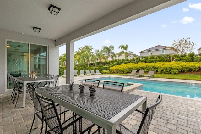 view of pool with a jacuzzi and a patio area