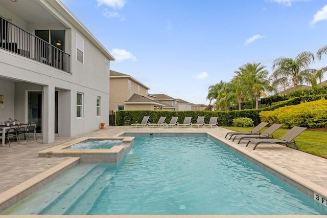 view of pool featuring an in ground hot tub and a patio area