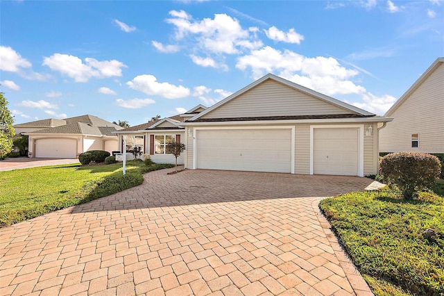 view of front of property with a front yard and a garage