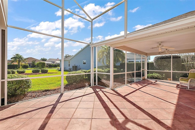 unfurnished sunroom featuring ceiling fan