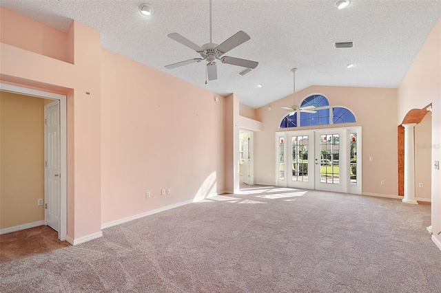 unfurnished living room with ceiling fan, light carpet, high vaulted ceiling, and french doors