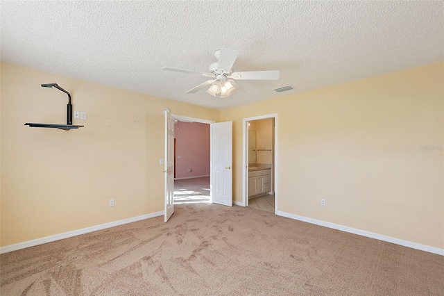 carpeted empty room featuring a textured ceiling and ceiling fan