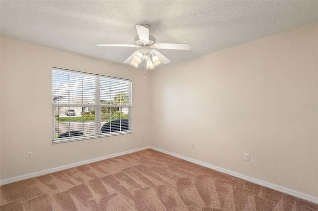 spare room featuring carpet, ceiling fan, and a textured ceiling