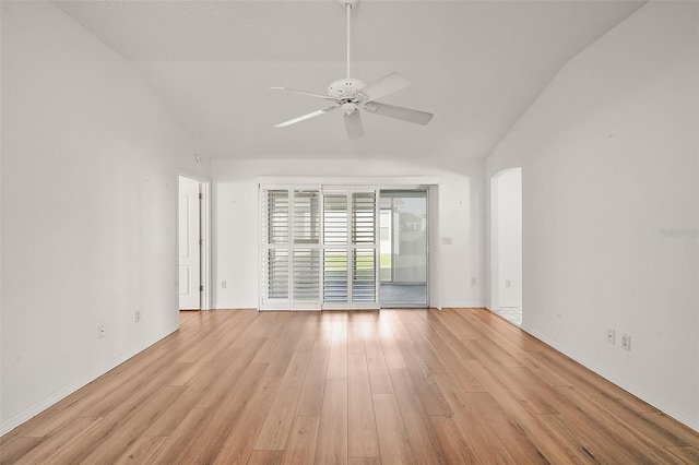 unfurnished room featuring a textured ceiling, light hardwood / wood-style flooring, vaulted ceiling, and ceiling fan