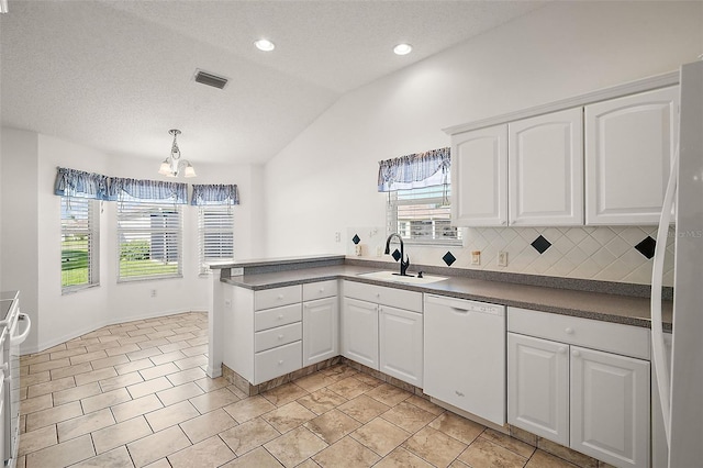 kitchen featuring vaulted ceiling, white cabinetry, sink, and white appliances