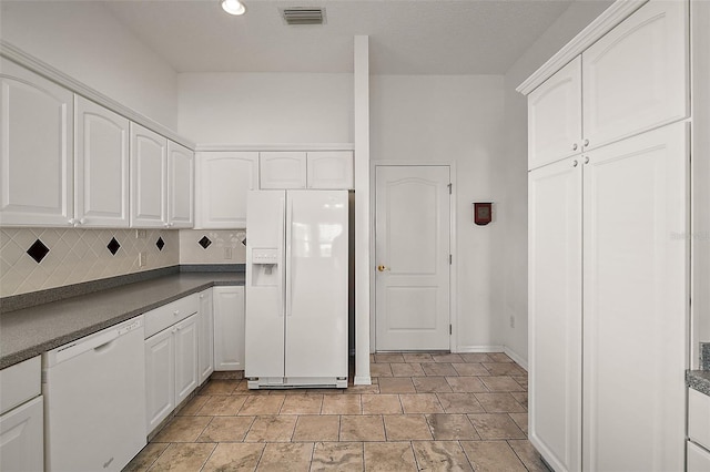 kitchen featuring white cabinets, white appliances, and tasteful backsplash