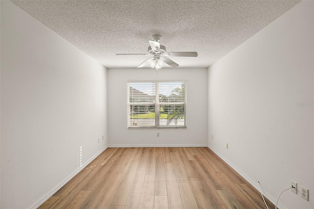 empty room with ceiling fan, light hardwood / wood-style floors, and a textured ceiling