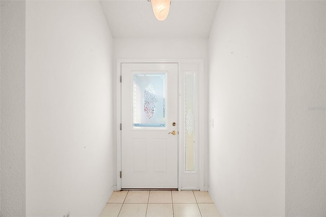 doorway with light tile patterned floors