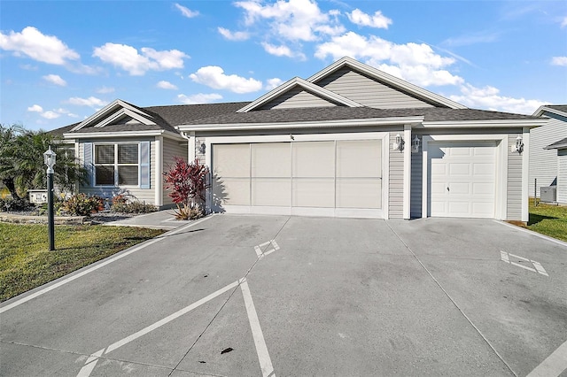 single story home with a front yard and a garage