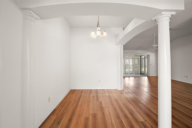 unfurnished dining area featuring hardwood / wood-style floors and ceiling fan with notable chandelier