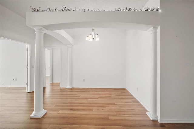 unfurnished dining area featuring a chandelier and light hardwood / wood-style floors