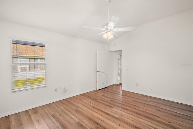 unfurnished room with ceiling fan, lofted ceiling, and light hardwood / wood-style flooring