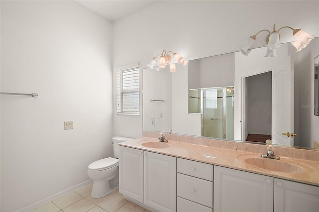 bathroom featuring tile patterned floors, vanity, an enclosed shower, and toilet