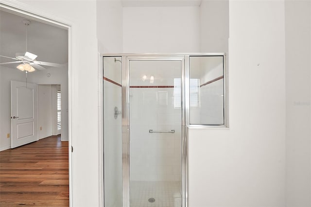 bathroom with walk in shower, ceiling fan, and hardwood / wood-style flooring