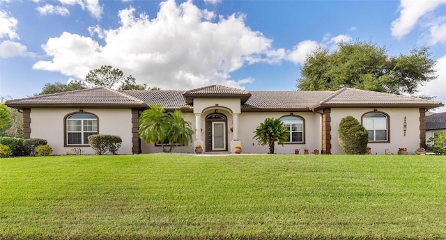 mediterranean / spanish home with a front yard