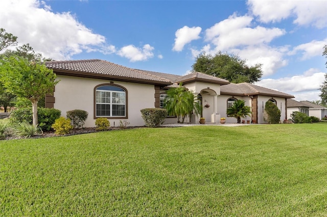 mediterranean / spanish-style house featuring a front yard