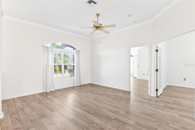 empty room featuring ceiling fan, ornamental molding, and light hardwood / wood-style flooring