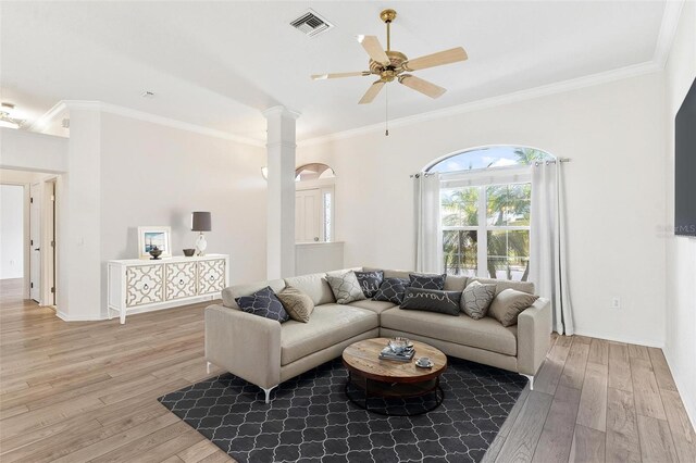 living room with crown molding, ceiling fan, and wood-type flooring