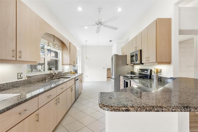 kitchen featuring light brown cabinetry, sink, light tile patterned floors, ceiling fan, and stainless steel appliances