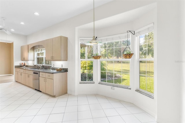 kitchen featuring stainless steel dishwasher, a healthy amount of sunlight, light brown cabinetry, and sink