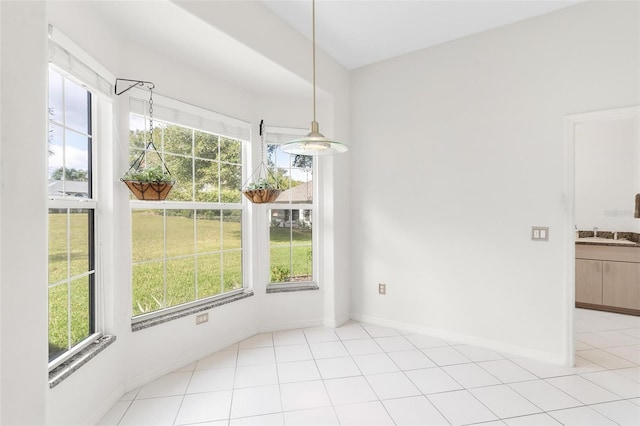 unfurnished dining area featuring a wealth of natural light and light tile patterned flooring