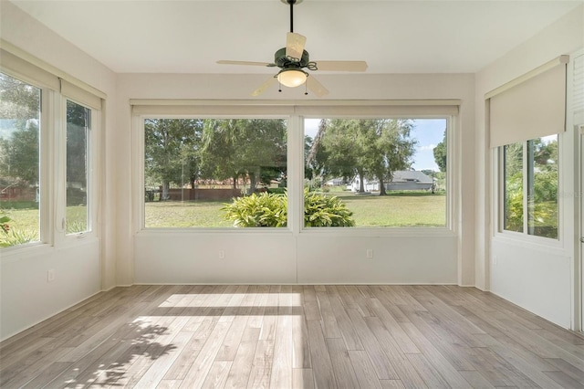 unfurnished sunroom with ceiling fan